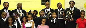 At the PS 15Q 1st Gala Black Tie Affair, Principal Antonio K’Tori with PS 15 students and honorees (L-R) Honorable Archie Spigner, Councilmen Leroy Comrie and James Sanders and Keynote Speaker Assemblyman William Scarborough.